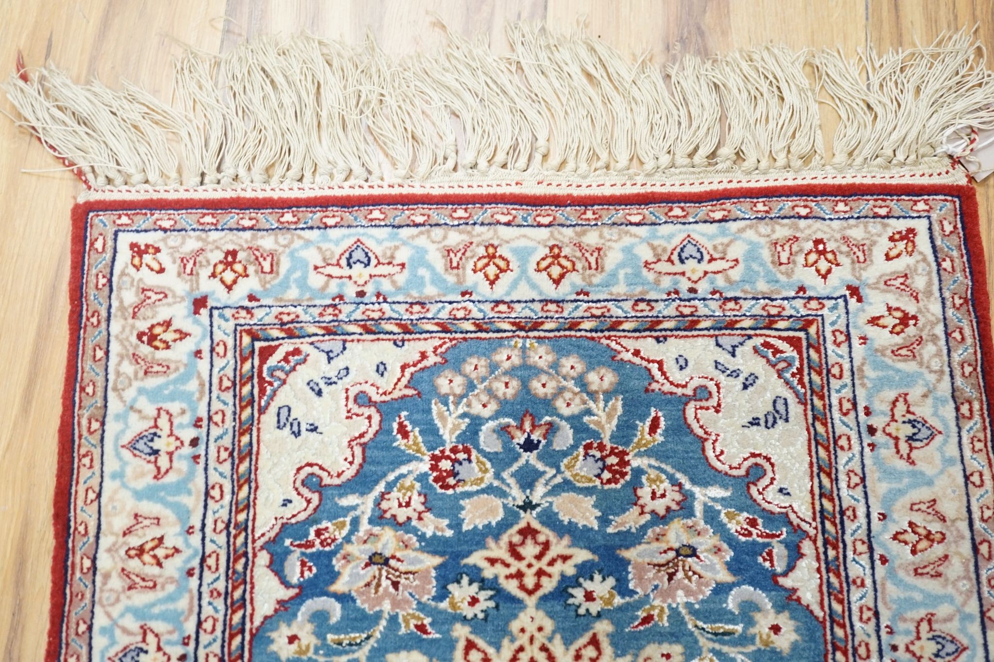 A north-west Persian blue-ground floor mat, signed, 42x53cm